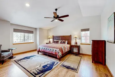 a bedroom with a bed and a ceiling fan at Sunlit Forest Haven in South Lake Tahoe