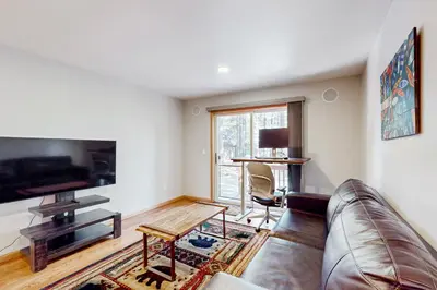 a living room with a couch and a table at Sunlit Forest Haven in South Lake Tahoe