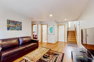 a living room with a brown leather couch at Sunlit Forest Haven in South Lake Tahoe