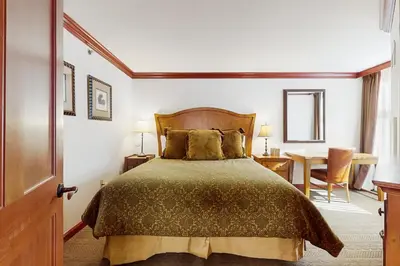 a bedroom with a bed and a table at Resort at Squaw Creek's 319 in Olympic Valley