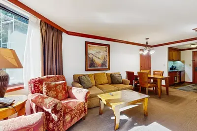 a living room with a couch and a table at Resort at Squaw Creek's 319 in Olympic Valley