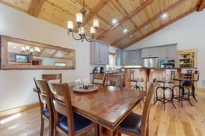 a kitchen and dining room with a wooden table and chairs at West Shore Retreat in Tahoma