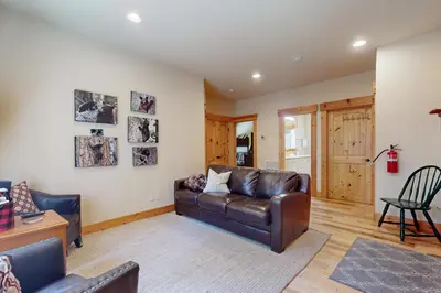 a living room with a leather couch and a table at West Shore Retreat in Tahoma