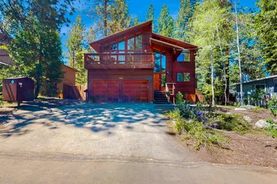a log home with a garage in the woods at Amazing Dollar Point Retreat in Tahoe City