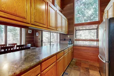 a kitchen with wooden cabinets and a refrigerator at Amazing Dollar Point Retreat in Tahoe City