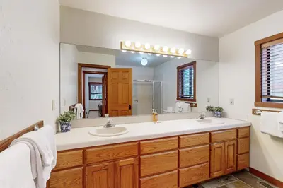 a bathroom with two sinks and a large mirror at Amazing Dollar Point Retreat in Tahoe City