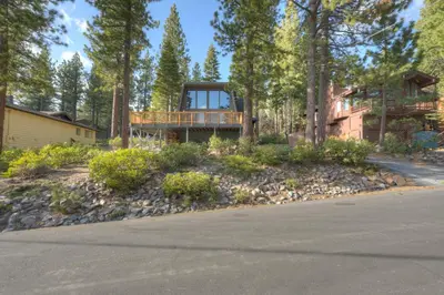 a house with a deck on the side of a road at Dollar Point in Tahoe City