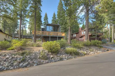 a house with a deck in the woods at Dollar Point in Tahoe City