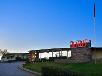 a hotel sign in front of a building with a sign at Foothills Motel in Auburn