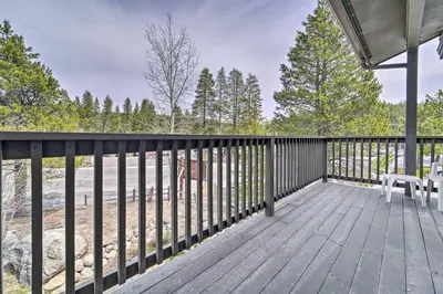 a large deck with a table and chairs on it at 2 Mi to Donner Lake Walkable Truckee Condo! in Truckee