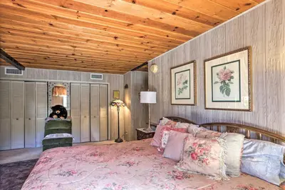 a bedroom with a bed and a wooden ceiling at Gorgeous Oakhurst Retreat with Swimming Hole! in Oakhurst