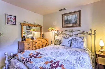 a bedroom with a bed and a dresser at Gorgeous Oakhurst Retreat with Swimming Hole! in Oakhurst