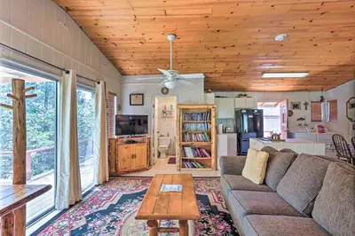 a living room with a couch and a table at Gorgeous Oakhurst Retreat with Swimming Hole! in Oakhurst