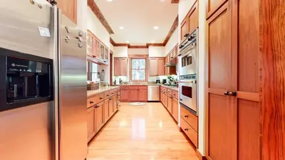 a kitchen with wooden cabinets and a stainless steel refrigerator at Lodestar #2001 home in Mammoth Lakes