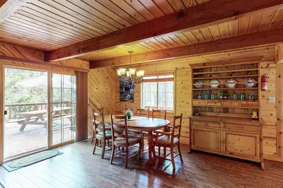 a dining room with a table and chairs in a cabin at Dollhouse in Arnold
