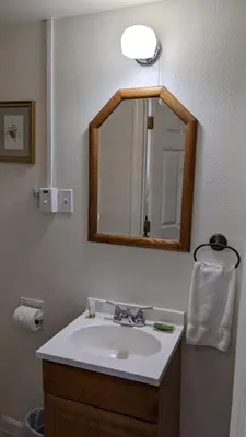 a bathroom with a sink and a mirror at Room #3 at the Apple Place in Miramonte