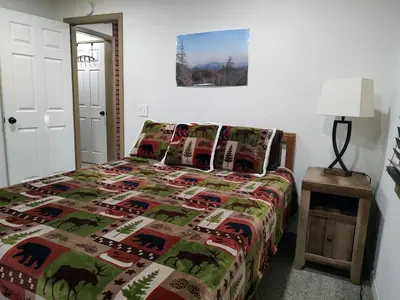 a bedroom with a bed with a quilt on it at Gilmore Cabin in Miramonte