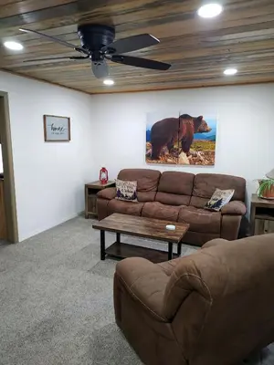 a living room with a couch and a table at Gilmore Cabin in Miramonte