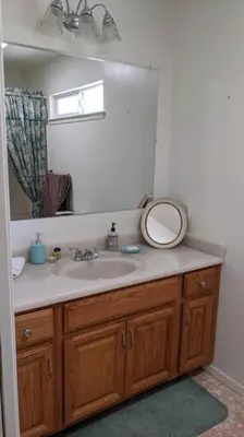 a bathroom with a sink and a mirror at Pierce's Cabin in Miramonte