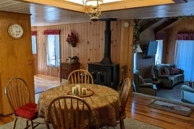 a dining room with a table and a stove at Pierce's Cabin in Miramonte