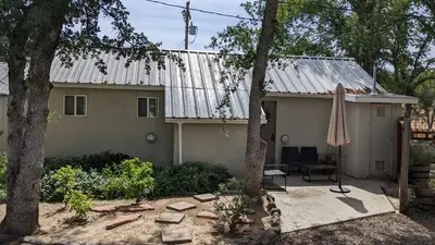a house with an old tin roof and a patio at Mimi's Cabin in Squaw Valley