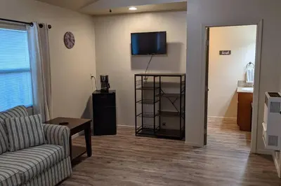 a living room with a couch and a tv on the wall at Mimi's Cabin in Squaw Valley