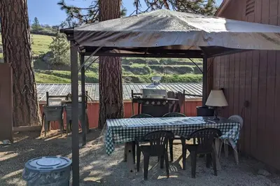 a gazebo with a table and chairs and a grill at The Apple Place Room #2 in Miramonte