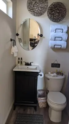 a bathroom with a toilet and a sink and a mirror at Sweet Mountain Cabin in Squaw Valley