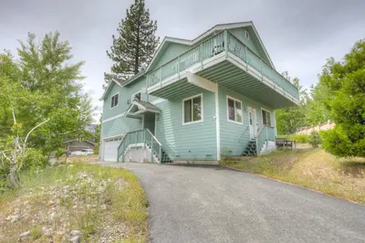 a green house with a road in front of it at Mountain-View Eden in South Lake Tahoe