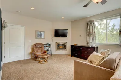 a living room with a couch and a tv and a chair at Mountain-View Eden in South Lake Tahoe