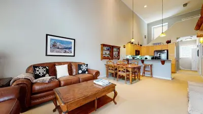 a living room with a couch and a table at Mammoth Green #205 condo in Mammoth Lakes
