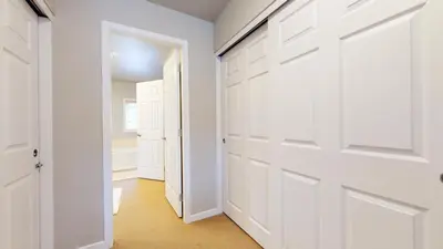 a white closet with white doors and a hallway at Mammoth Green #205 condo in Mammoth Lakes