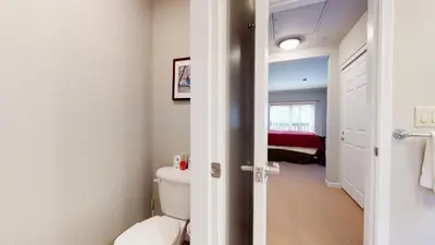 a bathroom with a toilet and a bedroom at Mammoth Green #205 condo in Mammoth Lakes