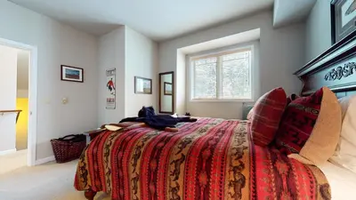 a bedroom with a large bed and a window at Mammoth Green #205 condo in Mammoth Lakes