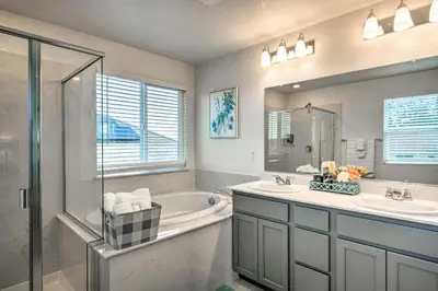 a bathroom with a tub and a sink and a shower at Sacramento Retreat with Yard about 13 Mi to Dtwn! in Elk Grove