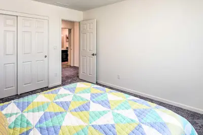an empty room with a colorful quilt on the floor at Sacramento Retreat with Yard about 13 Mi to Dtwn! in Elk Grove