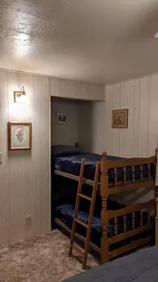 a bedroom with two bunk beds in a room at King's Cabin in Wilsonia