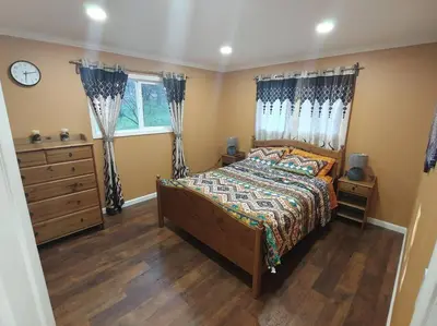 a bedroom with a bed and a dresser and a window at Mountain Cabin near Yosemite in Groveland