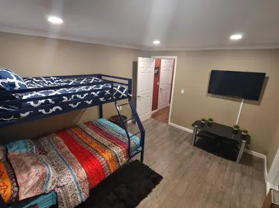 a bedroom with two bunk beds and a flat screen tv at Mountain Cabin near Yosemite in Groveland