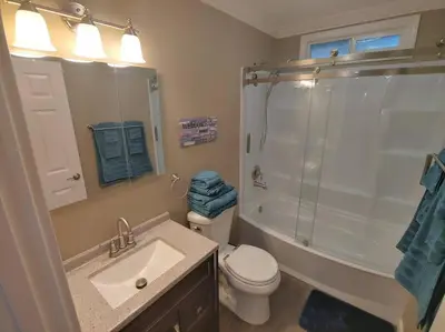 a bathroom with a toilet and a shower and a sink at Mountain Cabin near Yosemite in Groveland