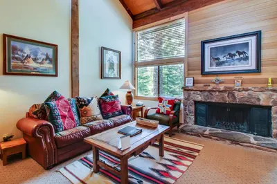 a living room with a couch and a fireplace at Mill Camp Gem in Ponderosa Fairway Estates