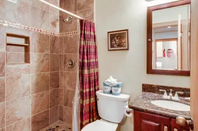 a bathroom with a toilet and a shower and a sink at Mill Camp Gem in Ponderosa Fairway Estates