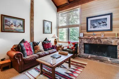 a living room with a couch and a fireplace at Mill Camp Gem in Ponderosa Fairway Estates
