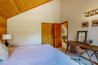 a bedroom with a bed and a desk and a table at Snowpeak Oasis in Truckee