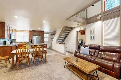 a living room with a leather couch and a table at Gold Bend Adventure in Truckee