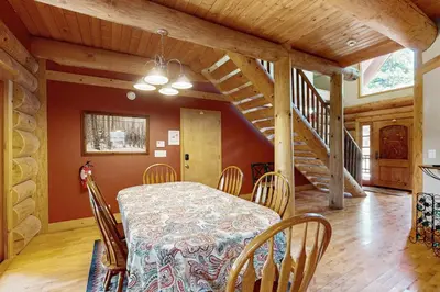 a dining room with a table and chairs and a staircase at Marshall Haven in South Lake Tahoe