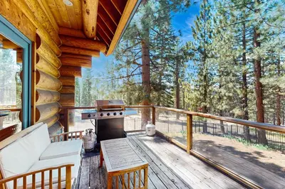 a screened in porch with a grill on a wooden deck at Marshall Haven in South Lake Tahoe