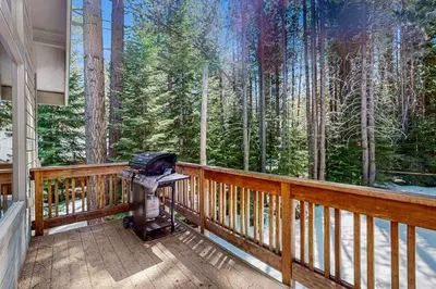 a screened in porch with a view of the woods at Miztec Charms in South Lake Tahoe