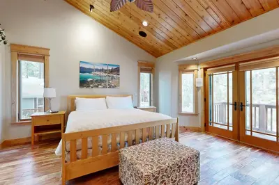 a bedroom with a bed and a wooden ceiling at High Meadows Gem in South Lake Tahoe