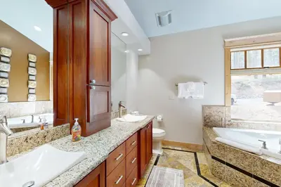 a bathroom with two sinks and a toilet and a tub at High Meadows Gem in South Lake Tahoe
